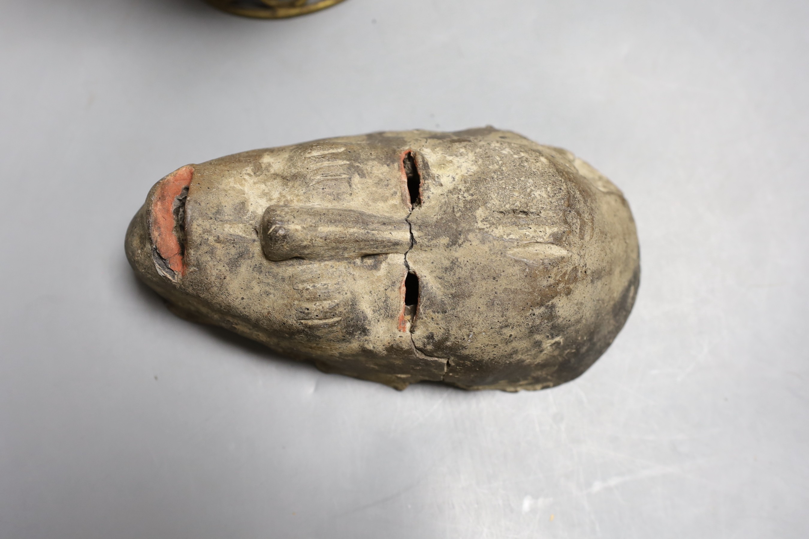 A Benin metal pot and figurative cover together with a pottery tribal mask. Tallest 26cm